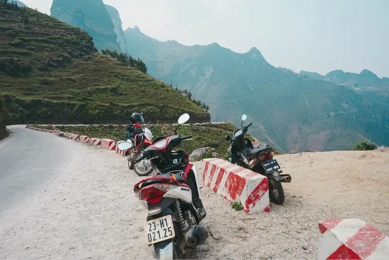 Motorbikes parked along Ha Giang mountain road ha giang motorcycle rental