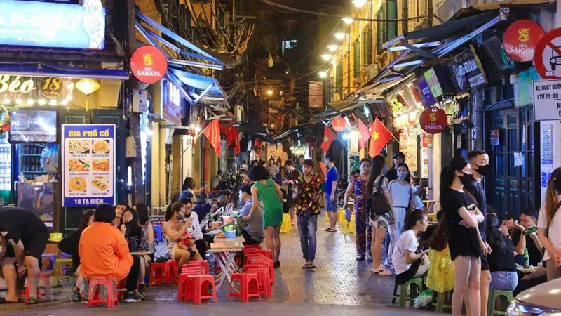 Locals relaxing along lively Hanoi streets night market hanoi time