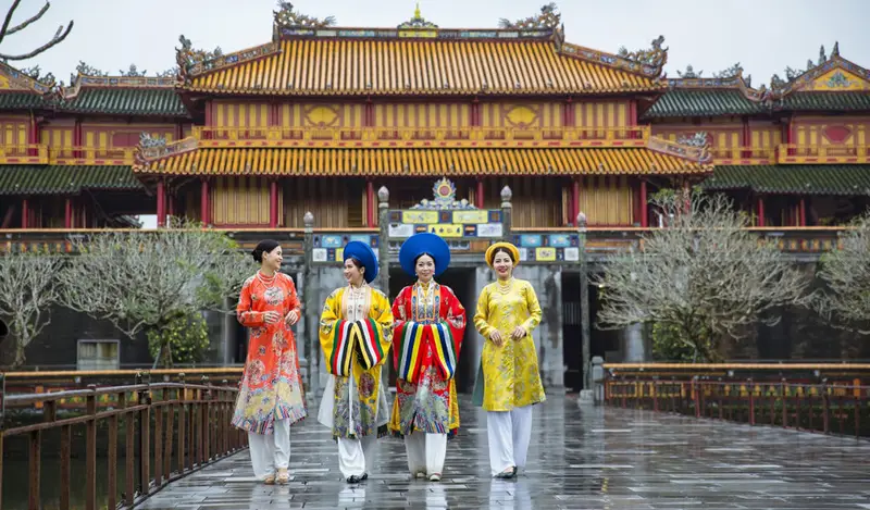 Visitors in traditional dress at Thai Hoa Palace imperial citadel hue